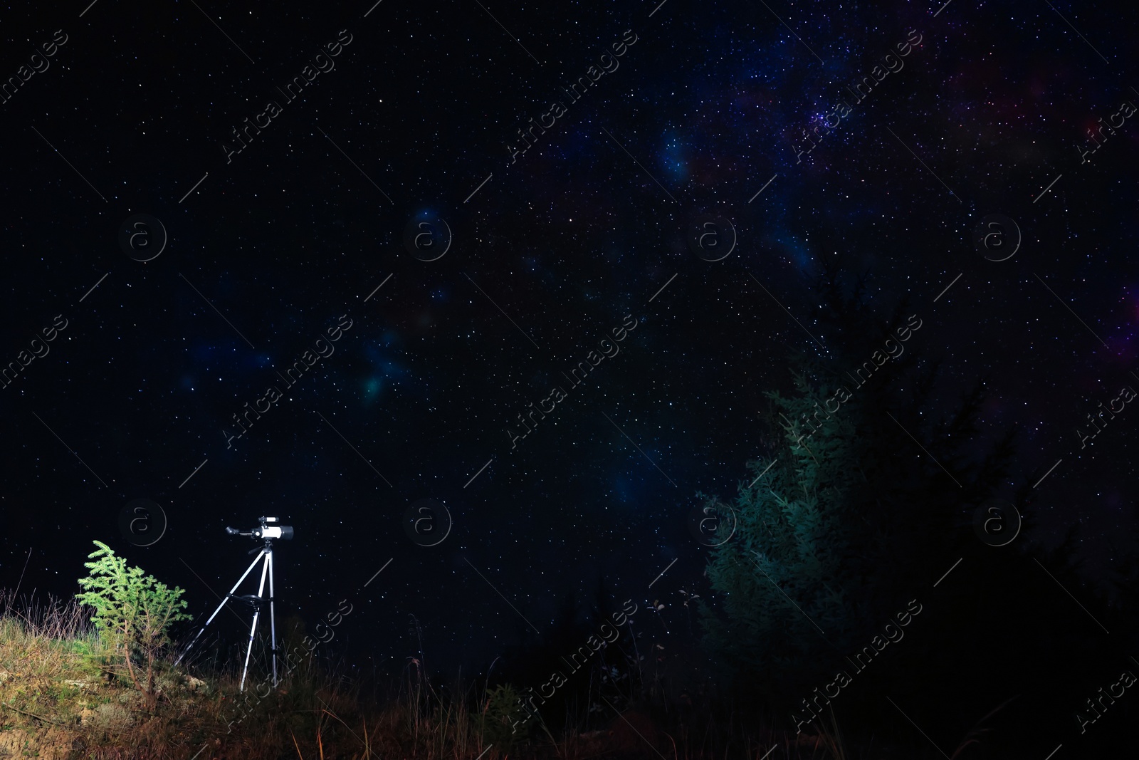 Photo of Modern telescope and beautiful sky in night outdoors, low angle view. Learning astronomy