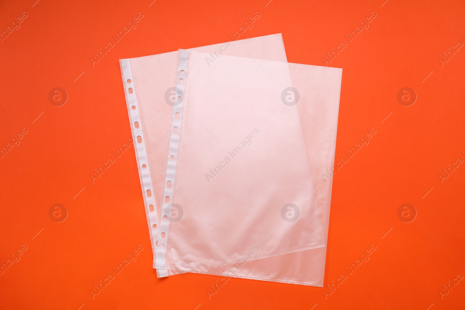 Photo of Punched pockets on orange background, flat lay