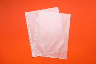 Photo of Punched pockets on orange background, flat lay