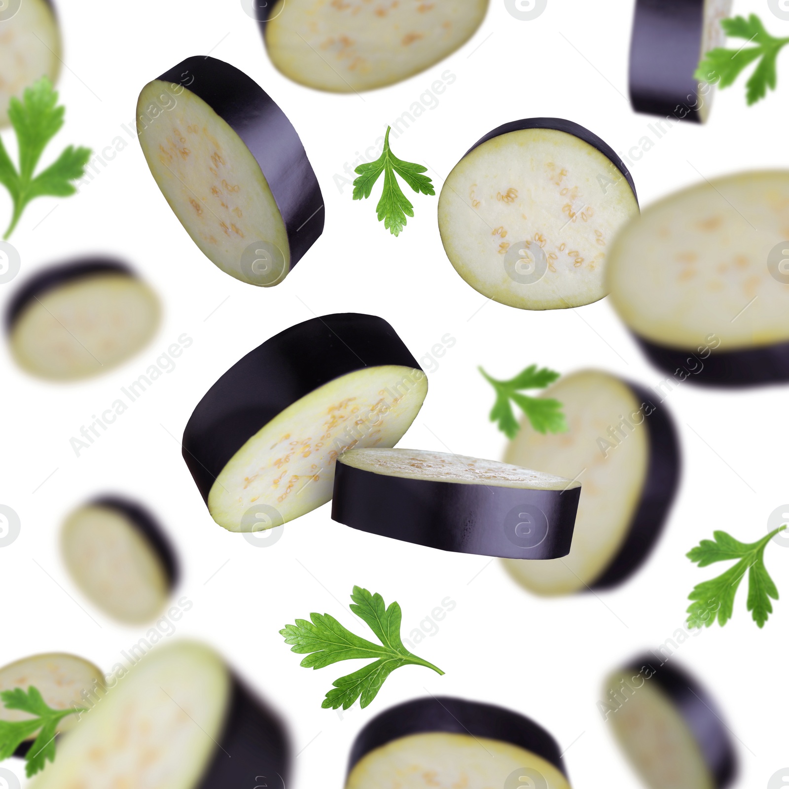 Image of Cut eggplants and parsley falling on white background