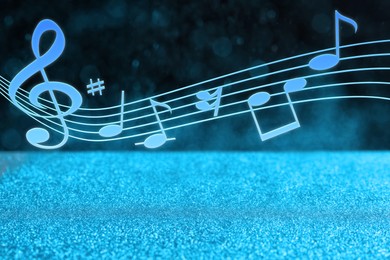 Music notes on dark background over glitter, bokeh effect