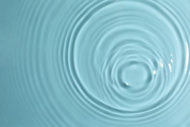 Photo of Closeup view of water with circles on turquoise background