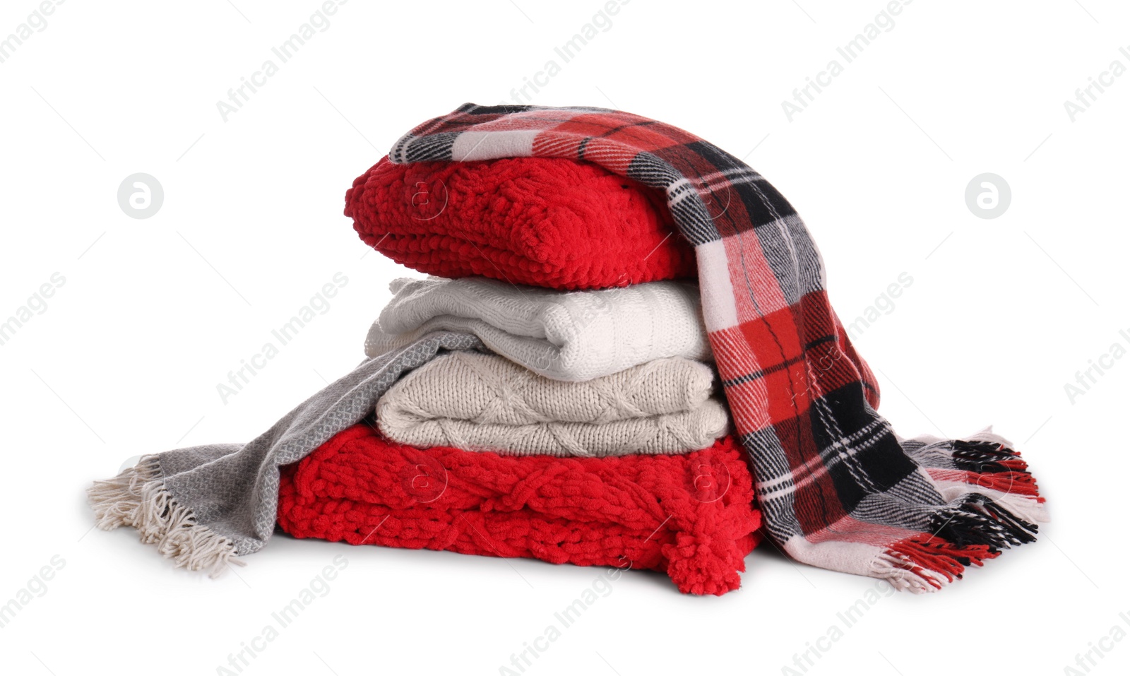 Photo of Stack of folded warm plaids with pillow on white background