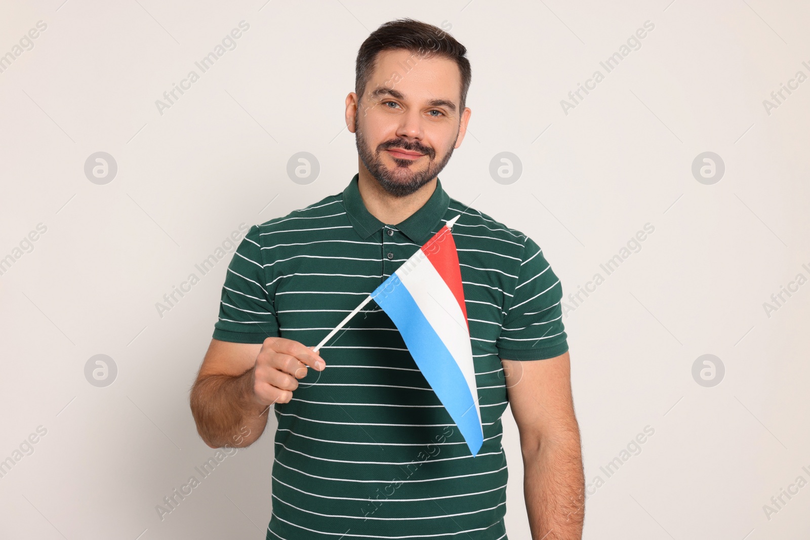 Photo of Man with flag of Netherlands on white background