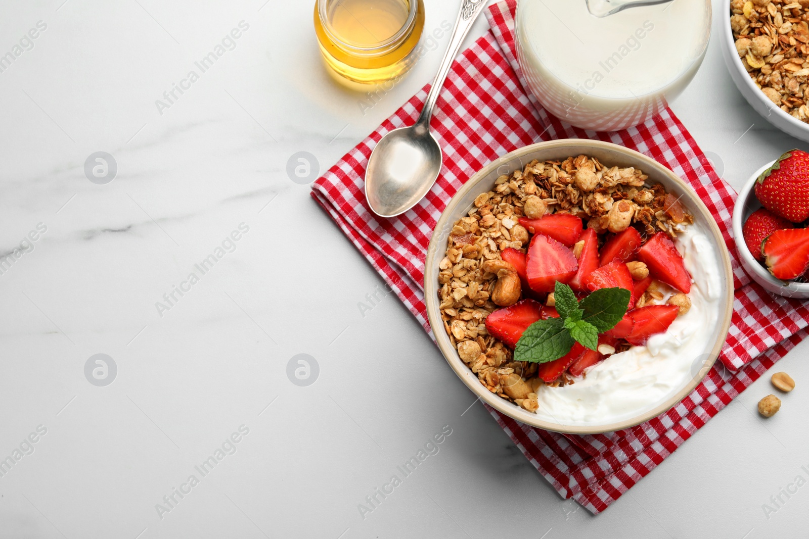 Photo of Flat lay composition with tasty granola and ingredients served on white marble table. Space for text