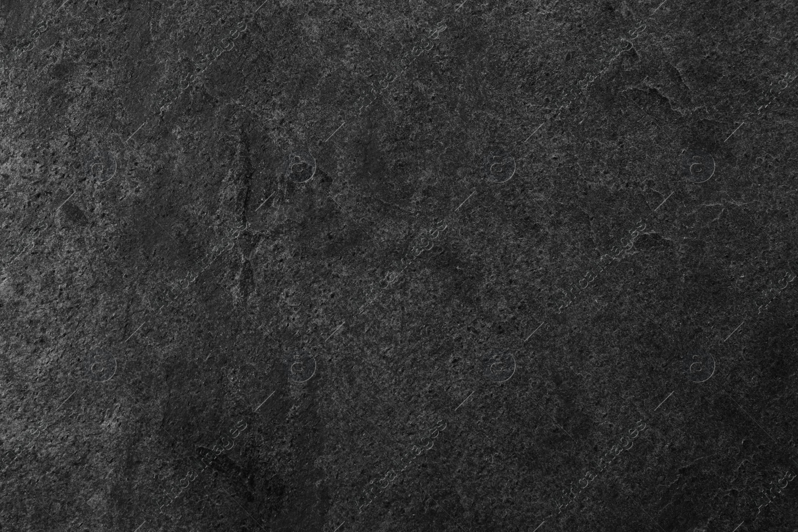 Photo of Texture of dark grey stone surface as background, closeup