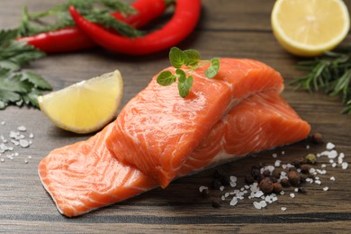 Photo of Fresh salmon and ingredients for marinade on wooden table