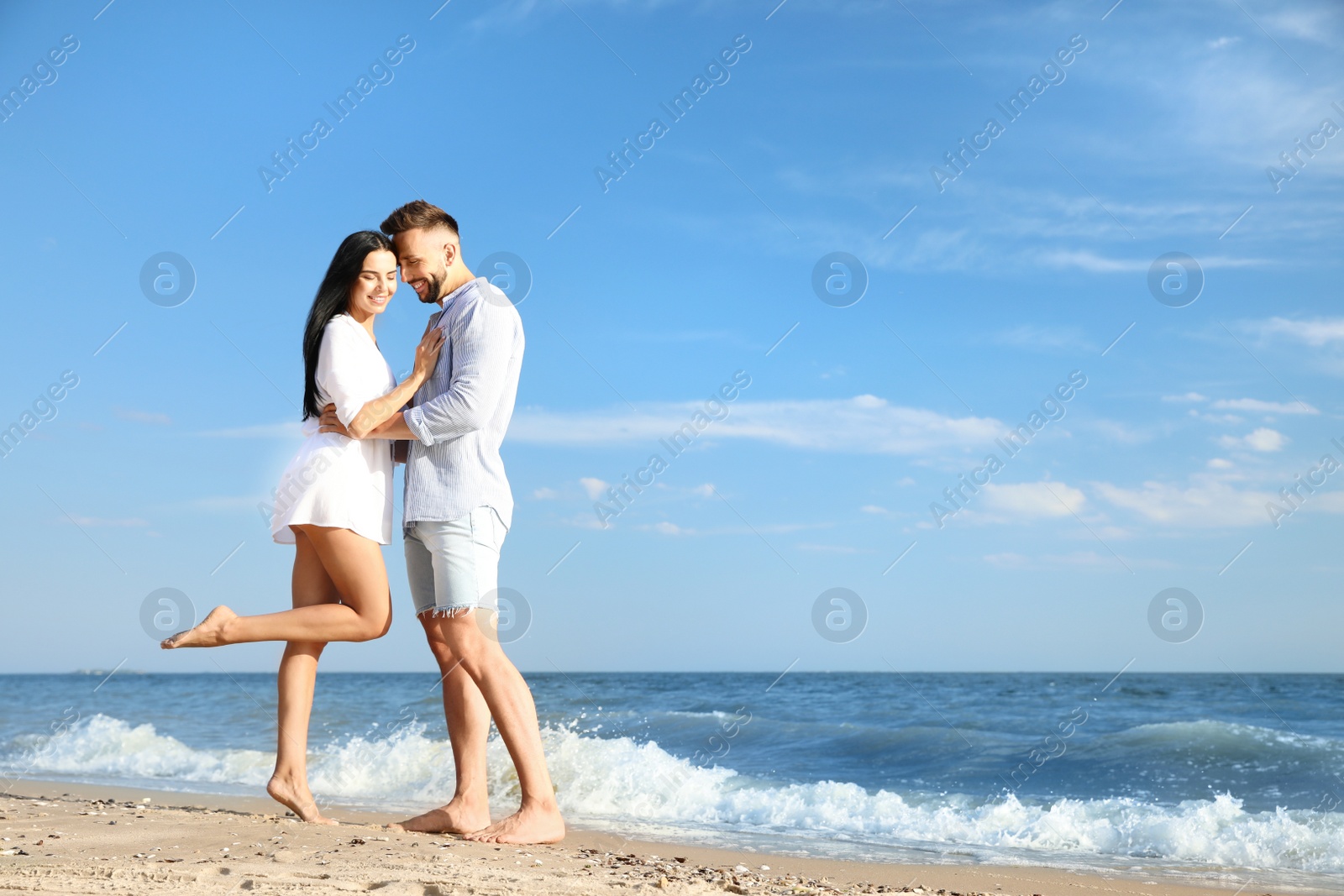 Photo of Happy young couple at beach on sunny day