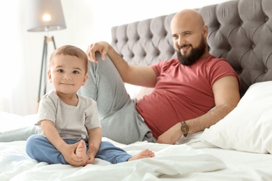 Dad and his little son spending time together at home