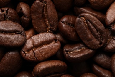 Aromatic roasted coffee beans as background, closeup