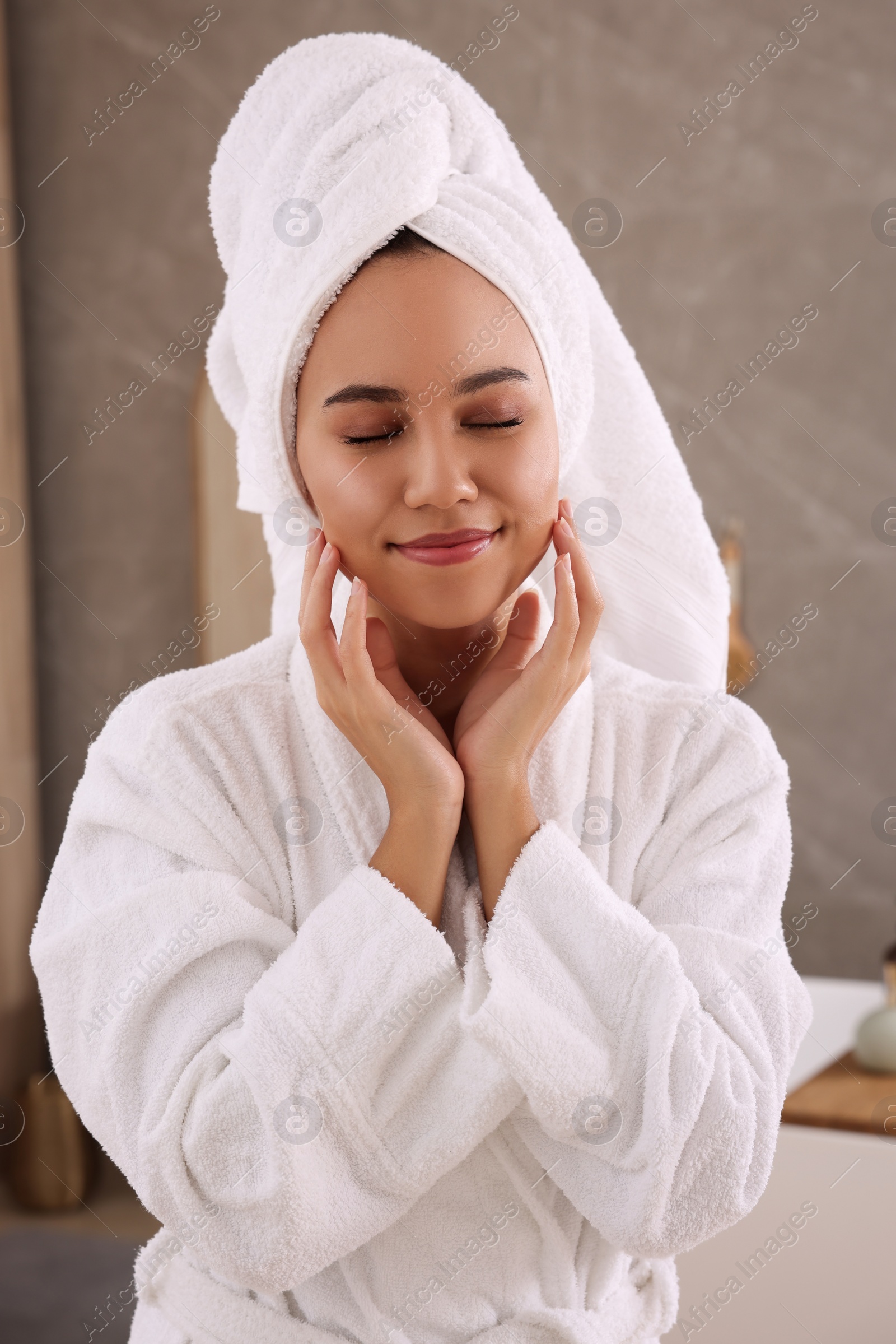 Photo of Beautiful African American woman in bathrobe at home