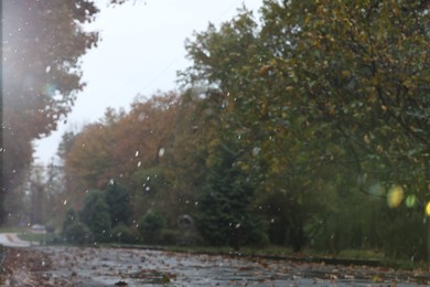 Photo of Blurred view of pathway in autumn park on rainy day