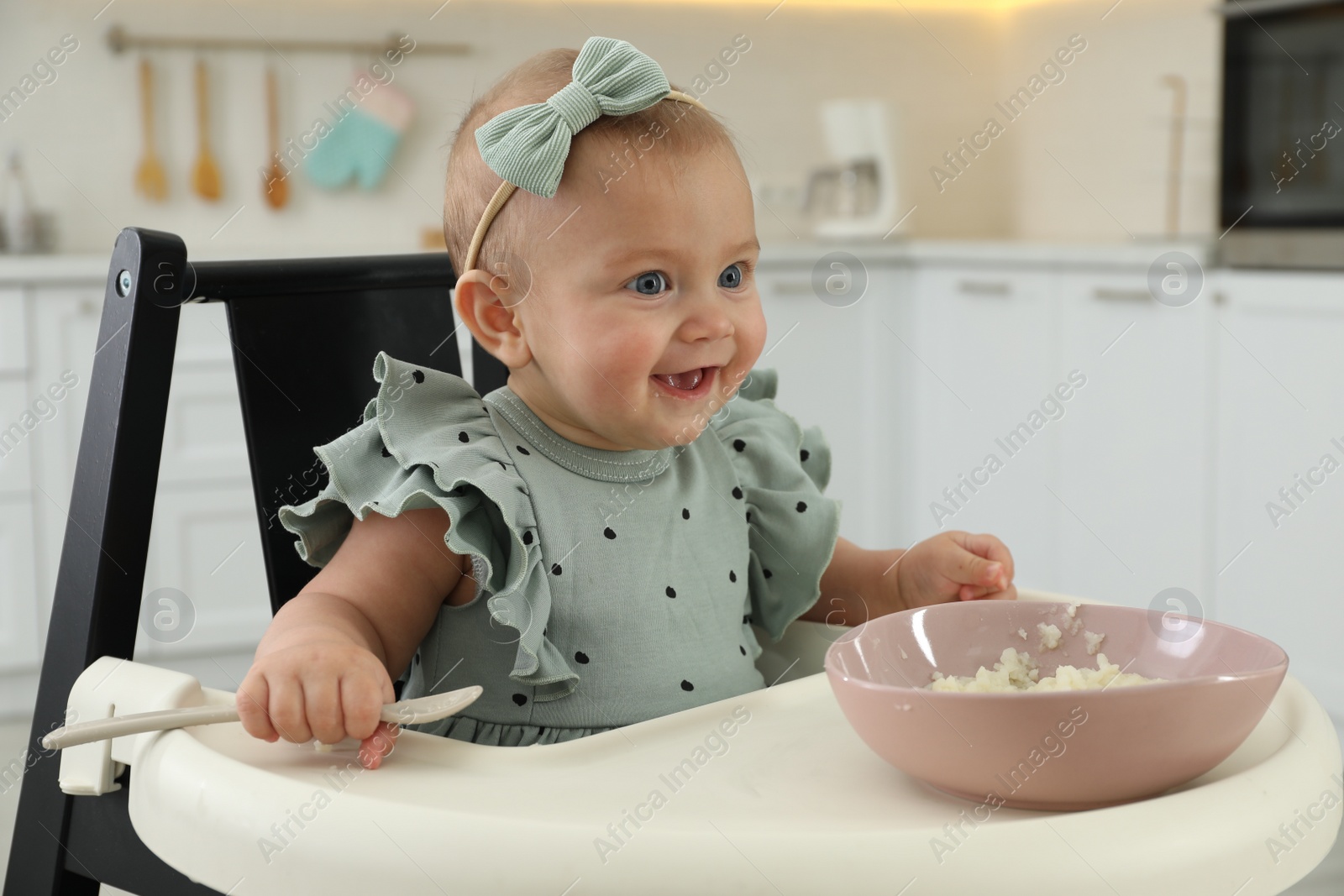 Photo of Cute little girl eating healthy food at home