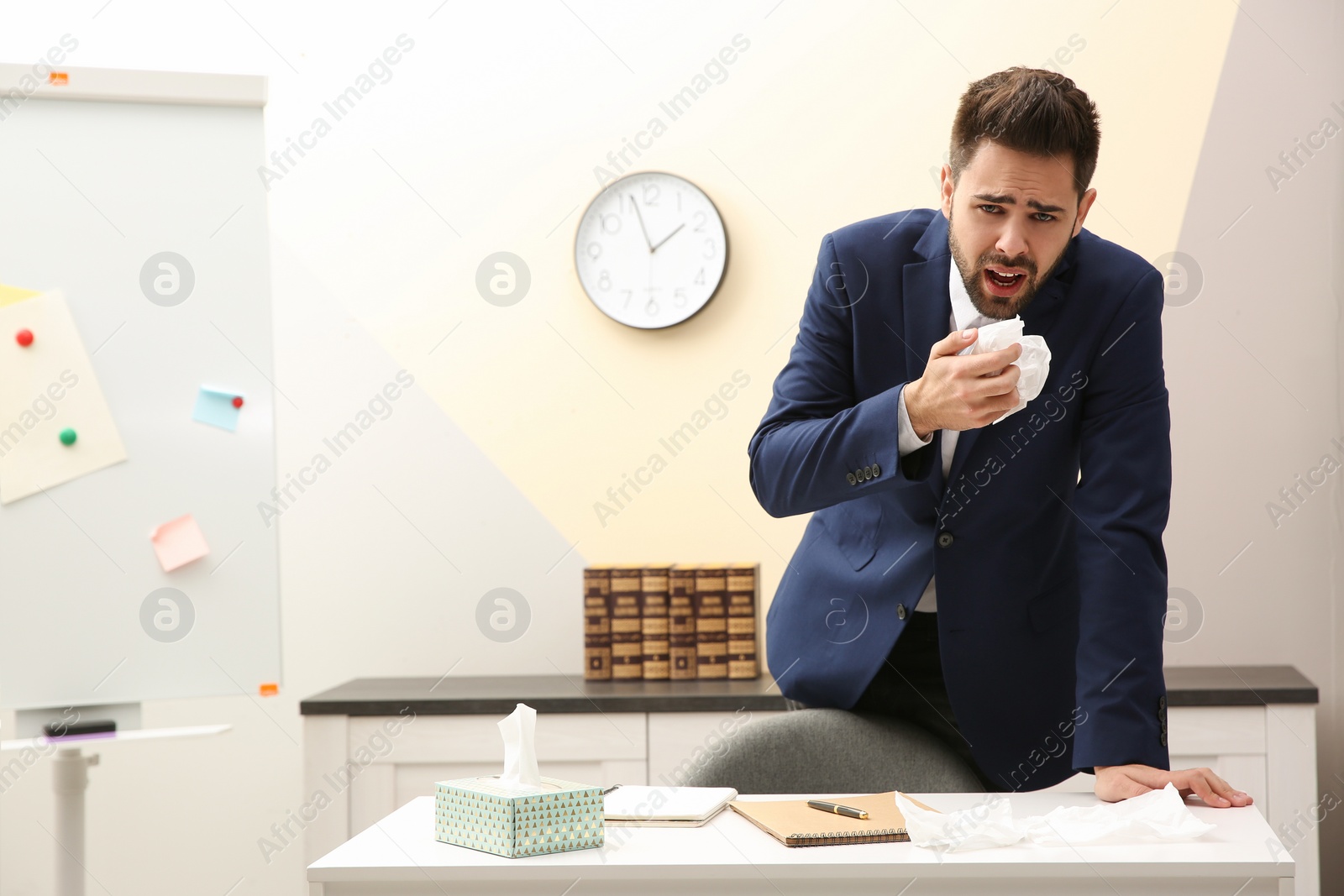 Photo of Sick young man at workplace. Influenza virus