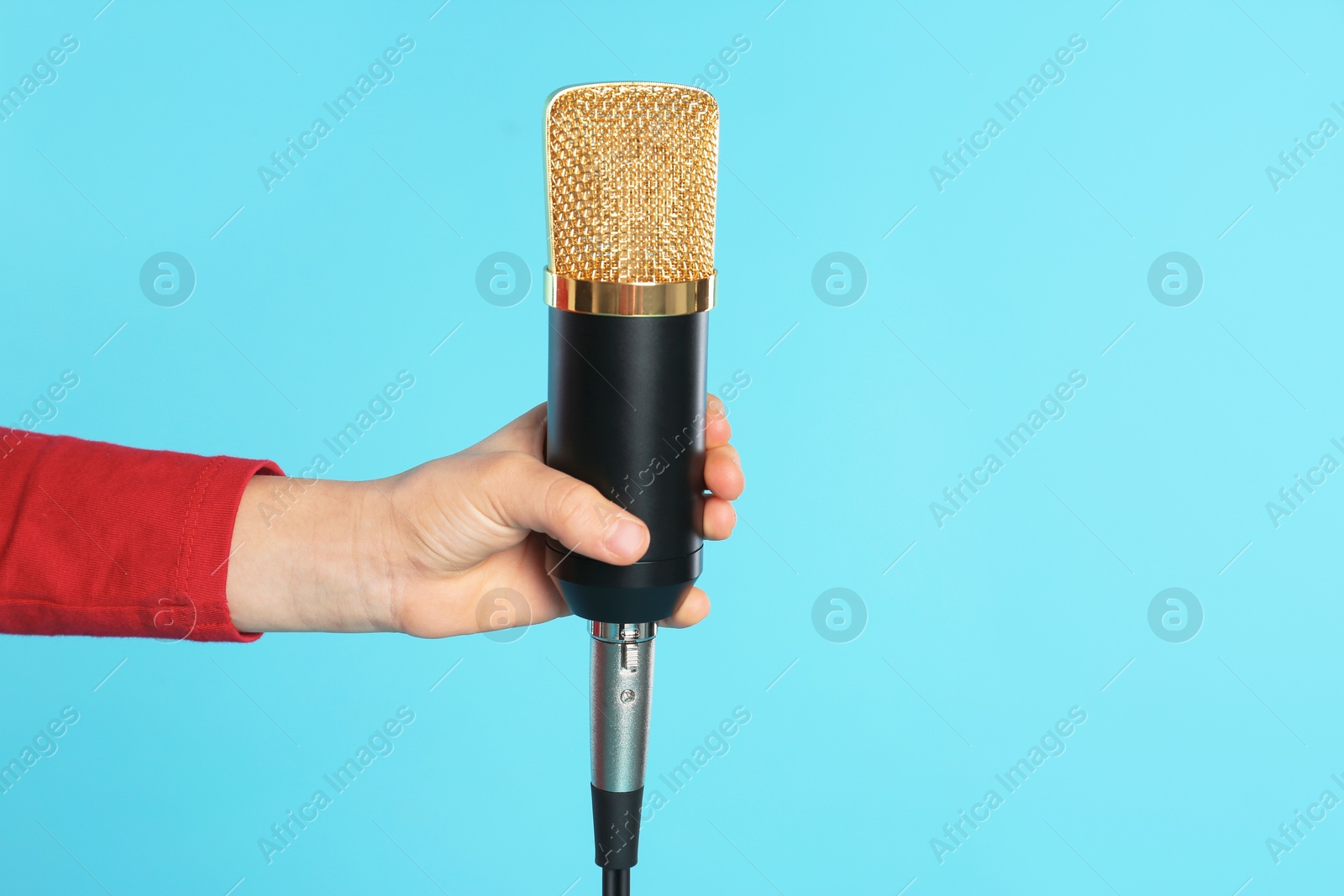 Photo of Child with microphone on color background, closeup. Space for text