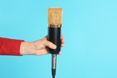 Photo of Child with microphone on color background, closeup. Space for text