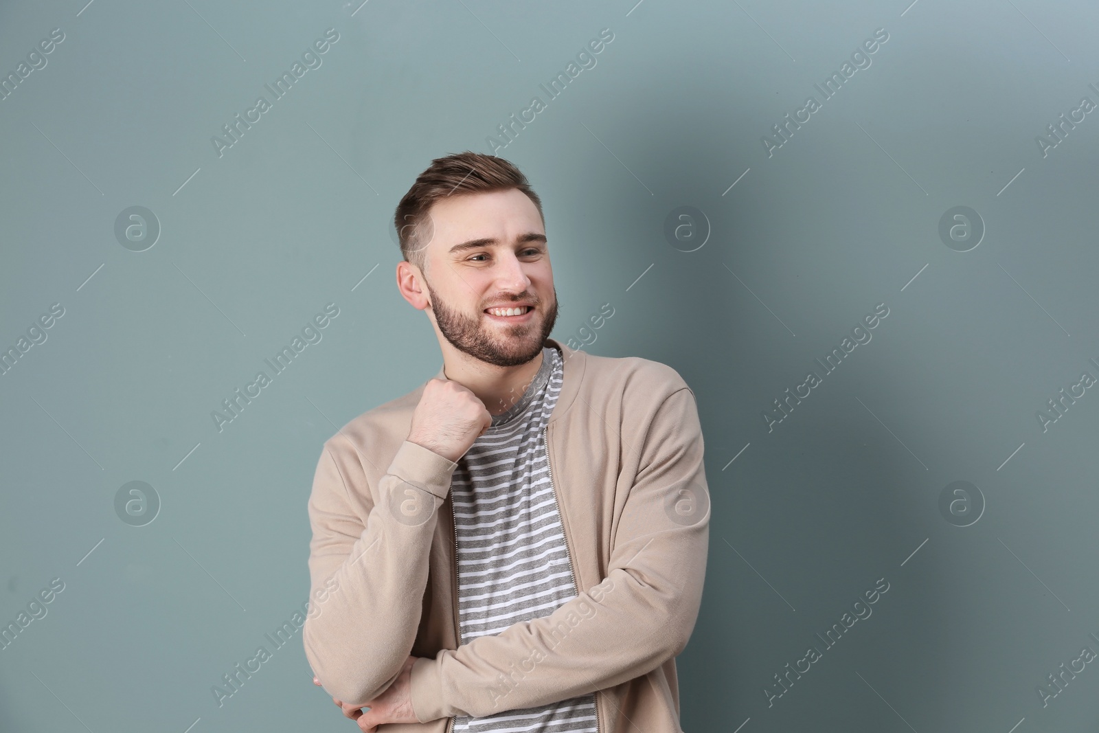 Photo of Portrait of confident young man on color background