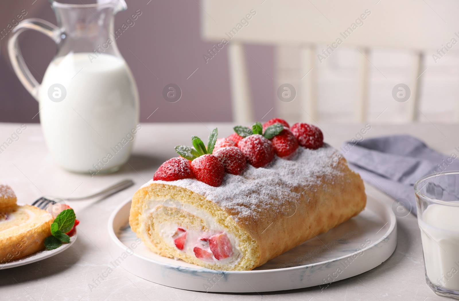 Photo of Delicious cake roll with strawberries and cream on light gray table