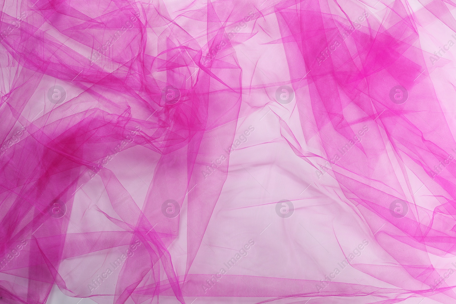 Photo of Beautiful pink tulle fabric on white background, top view