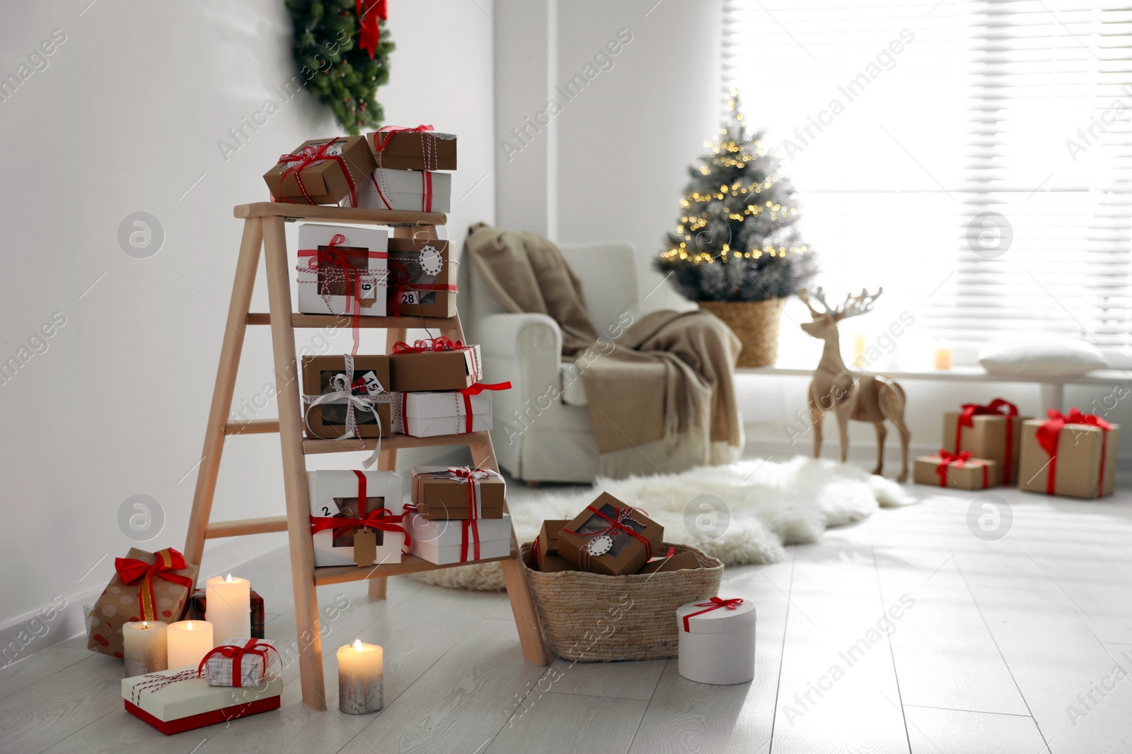 Photo of Advent calendar with gifts in room decorated for Christmas. Space for text