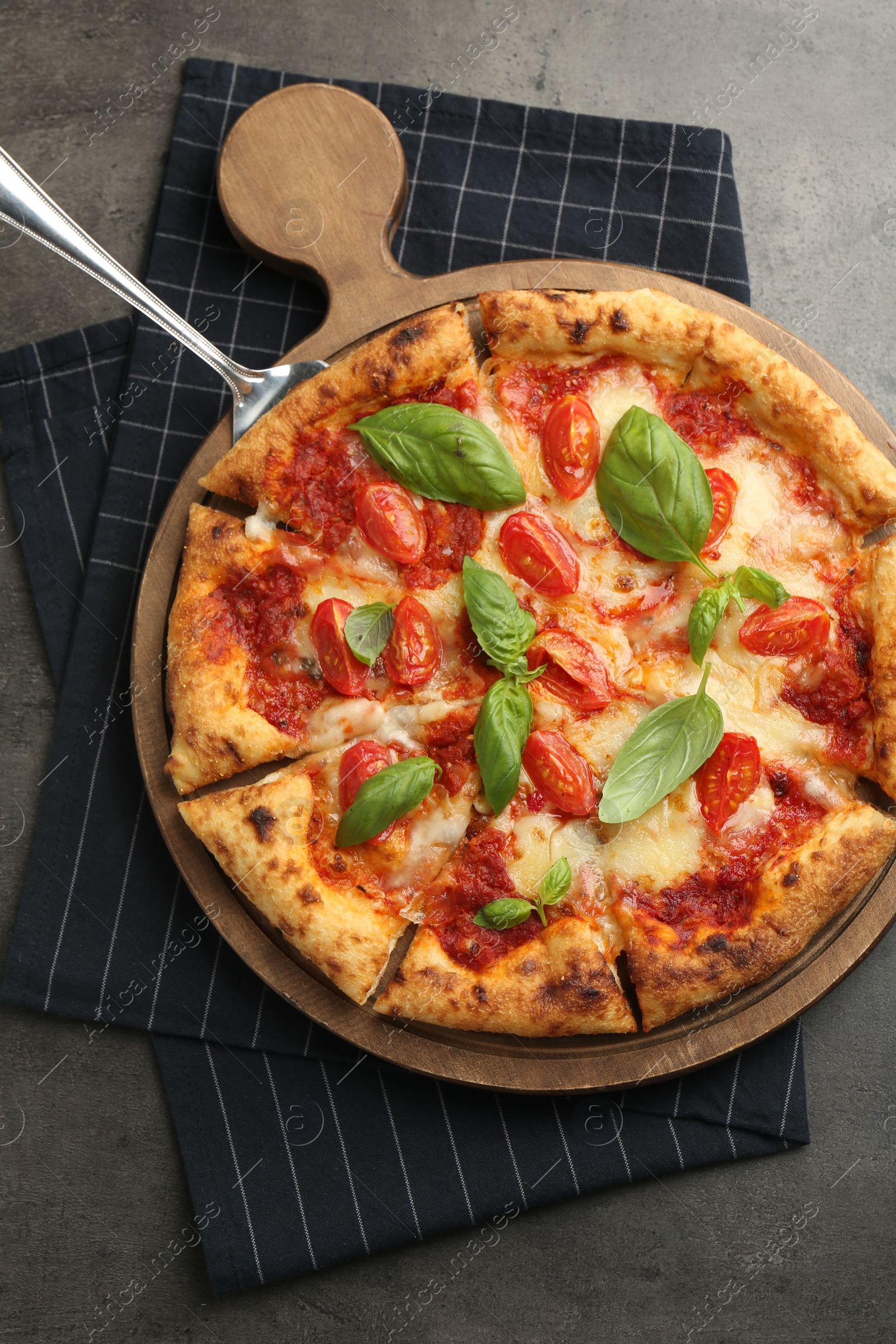 Photo of Delicious Margherita pizza on grey table, top view