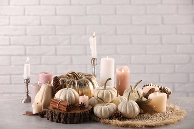 Beautiful composition with pumpkins and burning candles on table