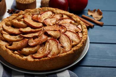 Photo of Delicious apple pie on blue wooden table, closeup