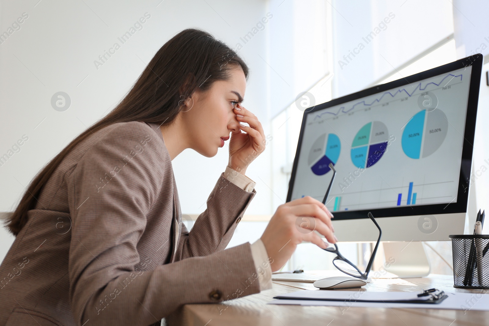 Photo of Businesswoman stressing out at workplace in office