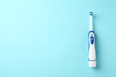 Photo of Electric toothbrush on color background. Dental care