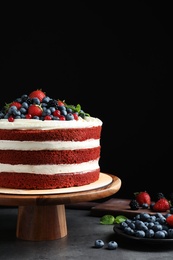 Photo of Composition with delicious homemade red velvet cake on black background