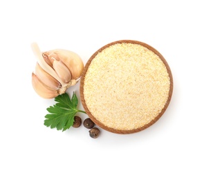 Bowl of dry garlic powder and parsley on white background, top view