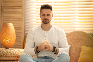 Photo of Young man during self-healing session in therapy room