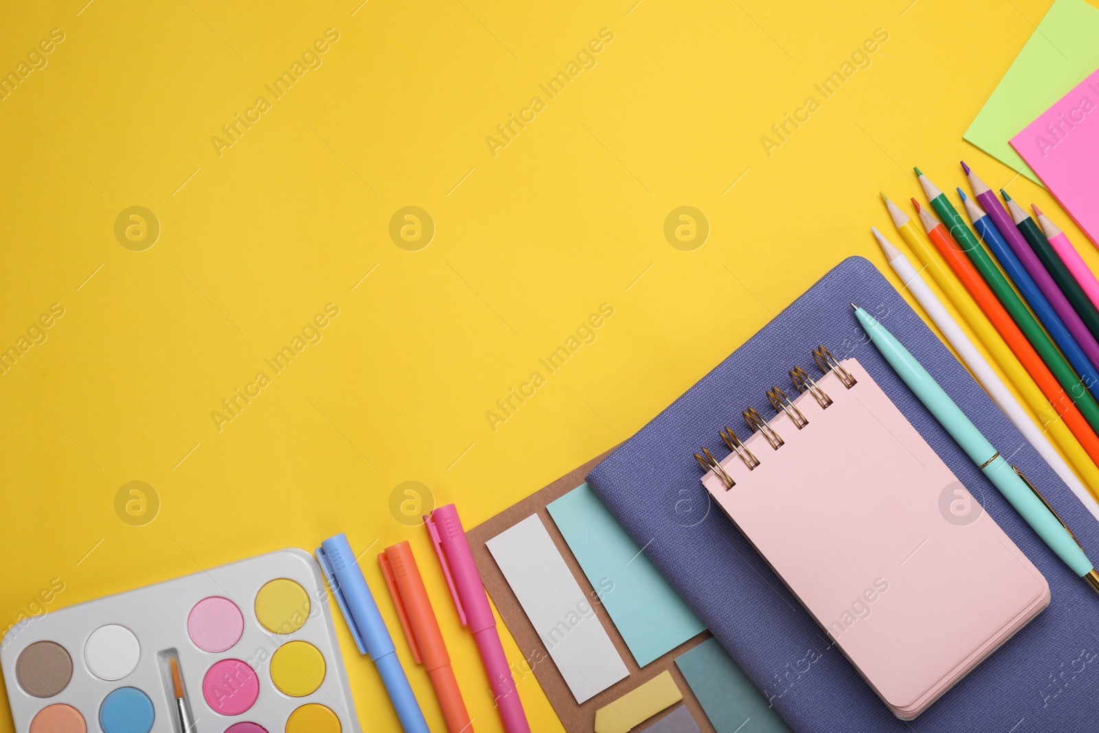 Photo of Flat lay composition with different school stationery on yellow background, space for text. Back to school