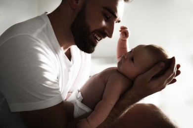 Image of Father with his newborn baby at home