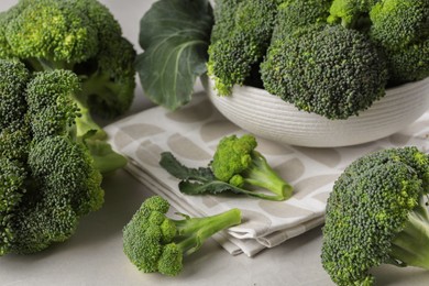 Photo of Fresh raw broccoli on white table, closeup