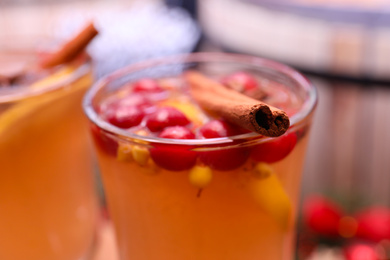 Photo of Tasty aromatic mulled wine on blurred background, closeup