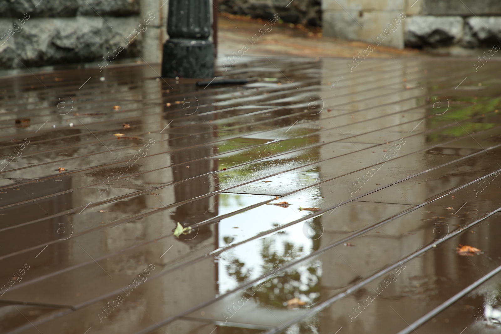 Photo of Wet city street after rain outdoors, closeup view