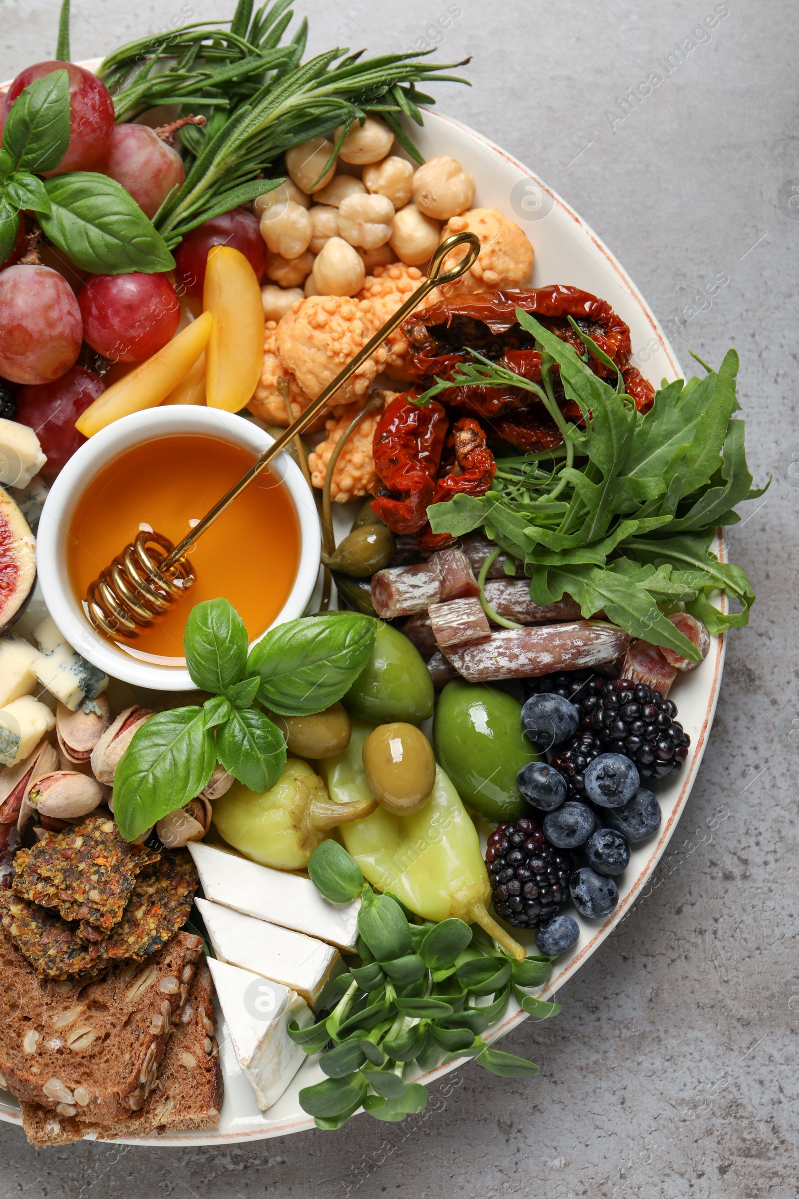 Photo of Set of different delicious appetizers served on light grey table, top view