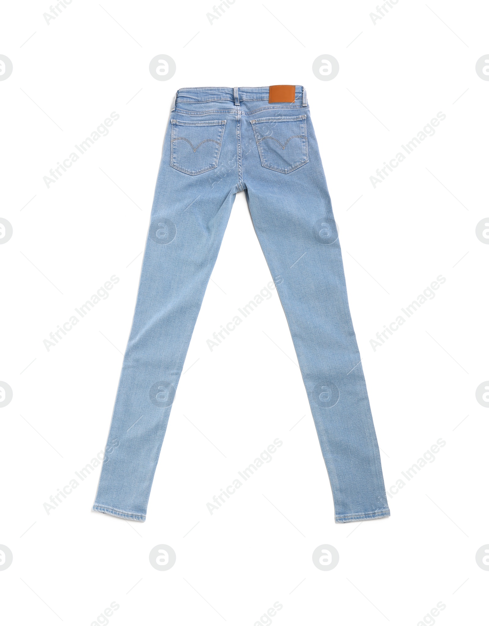 Photo of Stylish light blue jeans isolated on white, top view