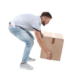 Photo of Full length portrait of young man lifting carton box on white background. Posture concept