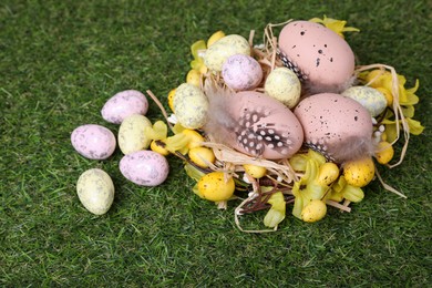 Photo of Festively decorated Easter eggs on green grass