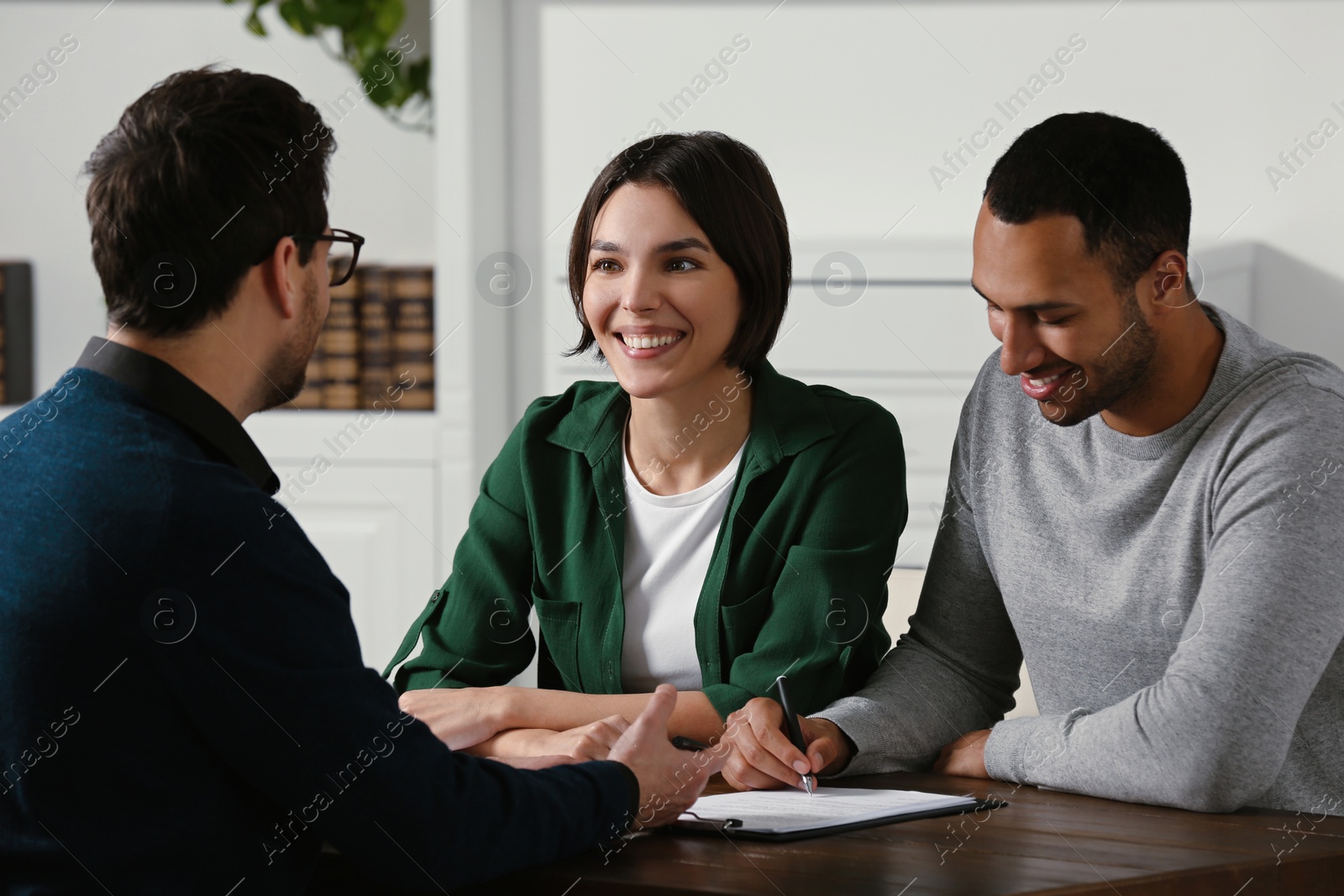 Photo of Professional notary working with couple in office