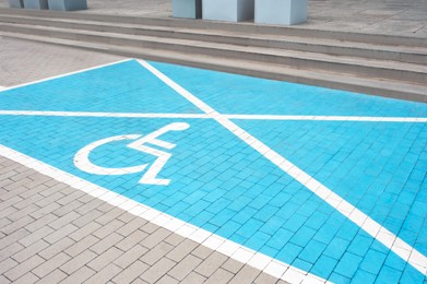 Photo of Car parking lot with wheelchair symbol outdoors