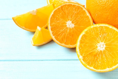 Photo of Fresh oranges on wooden background, space for text