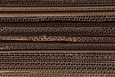 Photo of Sheets of brown corrugated cardboard as background, closeup