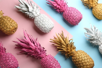 Photo of Many white, pink and golden pineapples on color background, flat lay. Creative concept