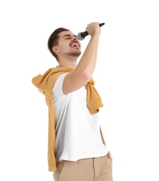 Young handsome man in casual clothes singing with microphone on white background