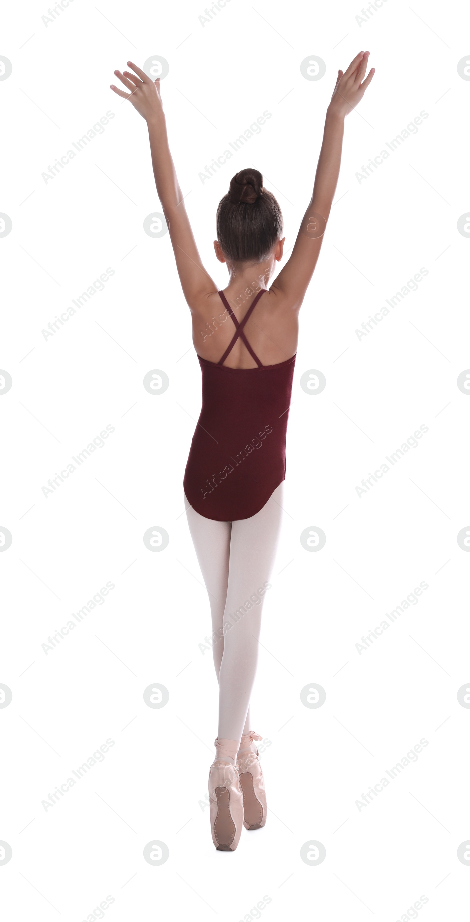 Photo of Little ballerina practicing dance moves on white background, back view