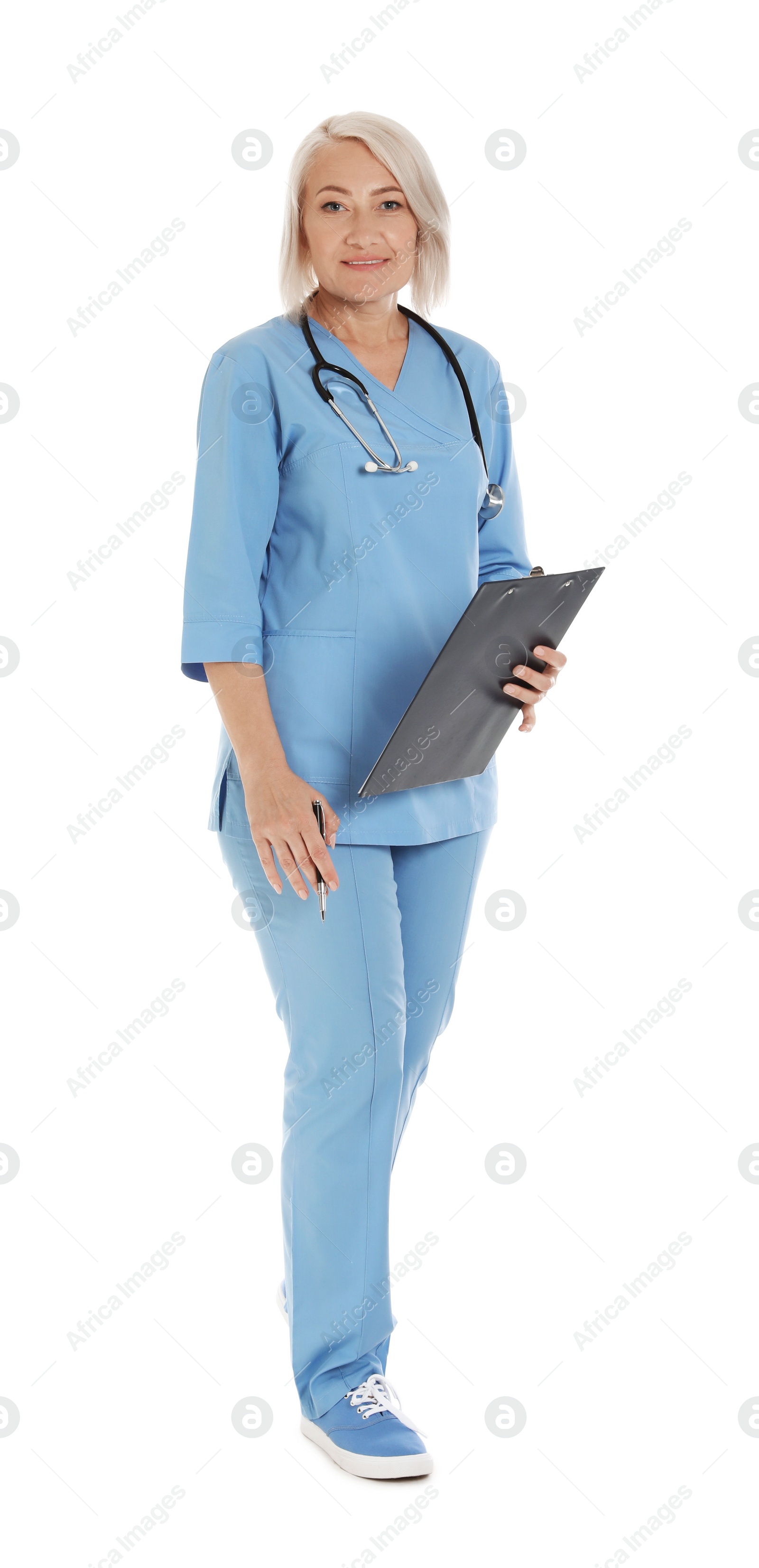 Photo of Full length portrait of female doctor in scrubs with clipboard isolated on white. Medical staff