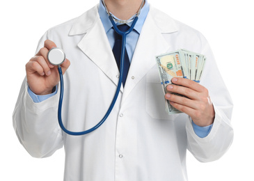 Photo of Doctor with bribe and stethoscope on white background, closeup. Corruption in medicine